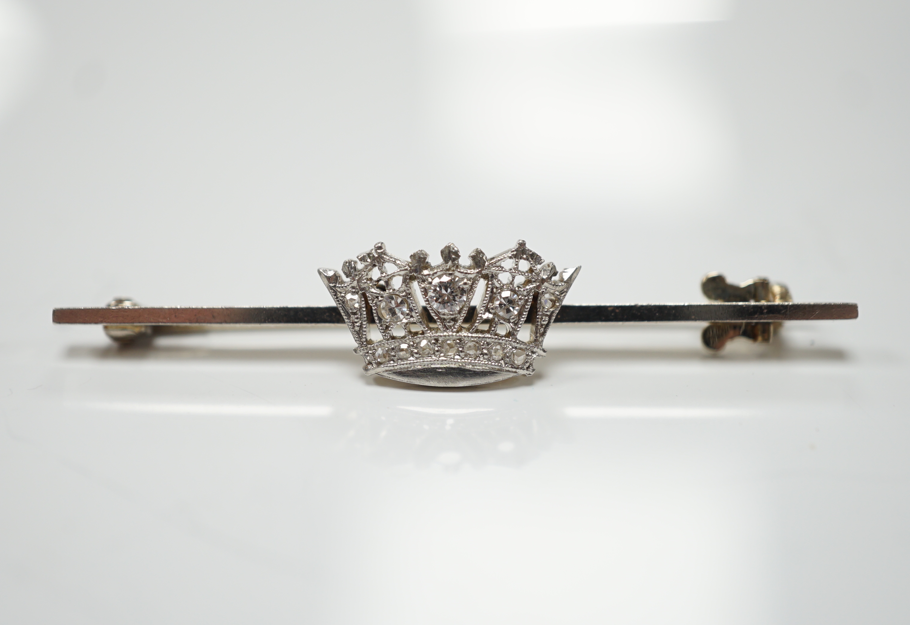A 1940's white metal (stamped 14ct and platinum) and diamond cluster set coronet bar brooch, 50mm, gross weight 4.1 grams.